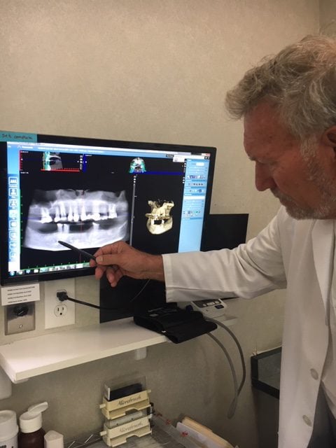 The doctor examining X-rays in a dental office